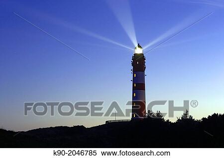 Stock Photography - Lighthouse with light beam in the night, Amrum, Northfrisian Islands, Schleswig-Holstein, Germany, Europe.. Fotosearch