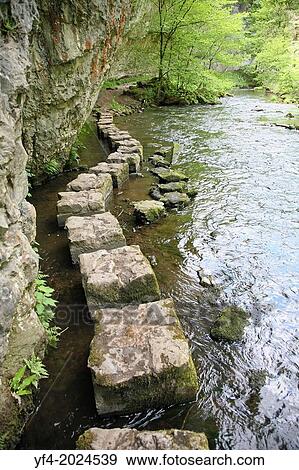 Limestone stepping stones on the River Wye at Chee Dale, Derbyshire Peak District National Park, England, UK. View Large Photo Image Stock Photo - Limestone stepping stones on the River Wye at Chee Dale, Derbyshire Peak District National Park, England, UK.. Fotosearch