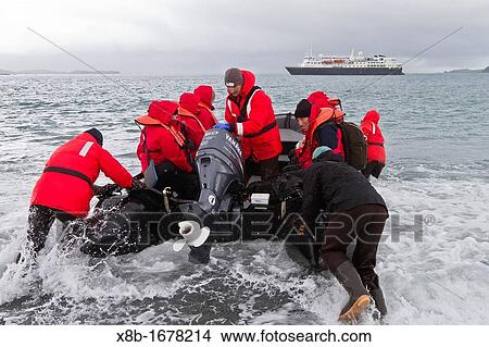 Lindblad and National Geographic Expeditions staff members conducting Zodiac landings in surf at Salisbury Plain, South Georgia Island, UK Overseas Protectorate View Large Photo Image Picture - Lindblad and National Geographic Expeditions staff members conducting Zodiac landings in surf at Salisbury Plain, South Georgia Island, UK Overseas Protectorate. Fotosearch