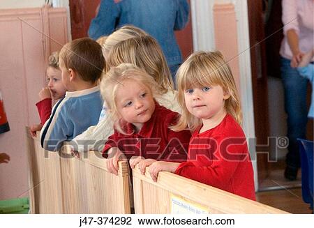 Stock Image - Line of 3 year old children at nursrey. Fotosearch