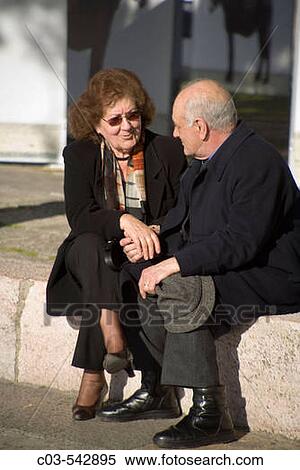 Lisbon, Portugal: Middle-aged couple holds hands and converses on grounds of Castelo de Sao Jorge (St. George's Castle). View Large Photo Image Stock Photography - Lisbon, Portugal: Middle-aged couple holds hands and converses on grounds of Castelo de Sao Jorge (St. George's Castle).. Fotosearch
