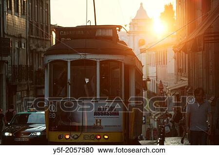 Lisbon's traditional yellow tram on the 28 line, passing at Cal? ada do Combro, the street that divides Bairro Alto and Bica neighborhoods. View Large Photo Image Stock Image - Lisbon's traditional yellow tram on the 28 line, passing at Cal? ada do Combro, the street that divides Bairro Alto and Bica neighborhoods.. Fotosearch
