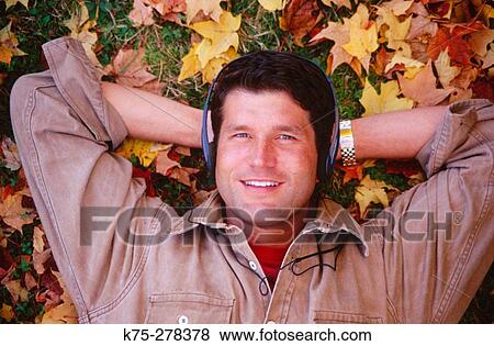 Listening to music on leafy lawn View Large Photo Image Stock Photo - Listening to music on leafy lawn. Fotosearch