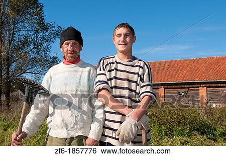 Lithuania, near Vilnius, Marijampole, Portrait of two farmers, father and son View Large Photo Image Stock Photograph - Lithuania, near Vilnius, Marijampole, Portrait of two farmers, father and son. Fotosearch