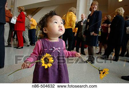 Little Asian girl with flowers View Large Photo Image Stock Image - Little Asian girl with flowers. Fotosearch