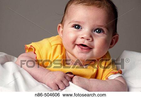 Stock Photograph - Little baby smiling in studio. Fotosearch