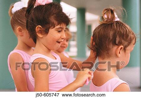 Stock Photo - Little ballerinas, brushing hair. Fotosearch