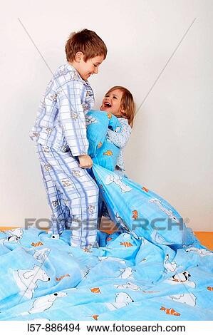 little boy and girl in bed having a pillow fight, studio, Oetwil am See, Zuerich, Switzerland View Large Photo Image Picture - little boy and girl in bed having a pillow fight, studio, Oetwil am See, Zuerich, Switzerland. Fotosearch