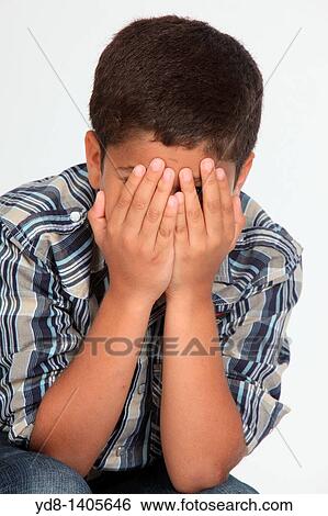 Stock Photograph - Little Boy covering his face with his hands. Fotosearch