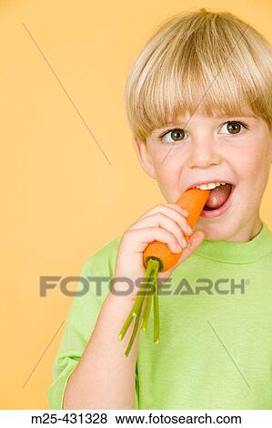 Little boy eating carrot View Large Photo Image Stock Photo - Little boy eating carrot. Fotosearch