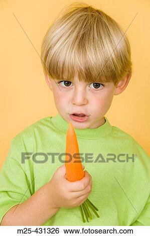 Little boy eating carrot View Large Photo Image Stock Photograph - Little boy eating carrot. Fotosearch
