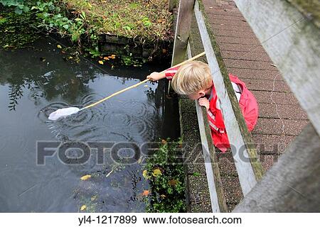 Stock Photo - Little boy fishing, Netherlands. Fotosearch