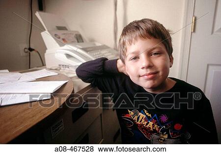 Little boy in home office, USA View Large Photo Image Stock Photo - Little boy in home office, USA. Fotosearch