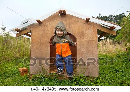 Little boy playing in dog house View Large Photo Image Stock Photography - Little boy playing in dog house. Fotosearch