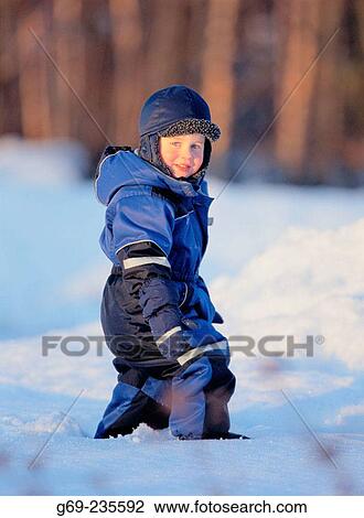 Stock Image - Little boy walking on snow. V? sterbotten, Sweden. Fotosearch