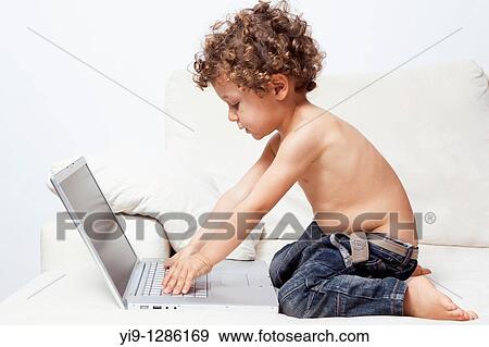 LITTLE BOY WITH LAPTOP COMPUTER View Large Photo Image Stock Photo - LITTLE BOY WITH LAPTOP COMPUTER. Fotosearch