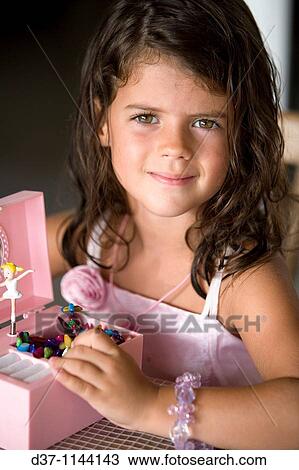 Little caucasian girl playing with a music box View Large Photo Image Stock Image - Little caucasian girl playing with a music box. Fotosearch