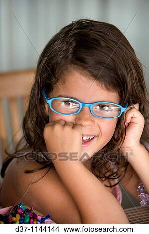 Little caucasian girl wearing glasses and smiling View Large Photo Image Picture - Little caucasian girl wearing glasses and smiling. Fotosearch