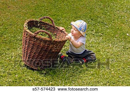 little girl (1 year old) playing with wicker basket at the garden View Large Photo Image Stock Image - little girl (1 year old) playing with wicker basket at the garden. Fotosearch