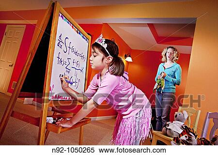 Little girl, age 6 writing on board and mom standing by in awe View Large Photo Image Stock Photography - Little girl, age 6 writing on board and mom standing by in awe. Fotosearch