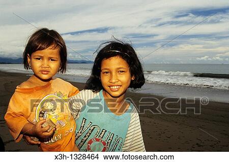 little girl and baby on the beach, Sumatra island, Republic of Indonesia, Southeast Asia and Oceania View Large Photo Image Picture - little girl and baby on the beach, Sumatra island, Republic of Indonesia, Southeast Asia and Oceania. Fotosearch