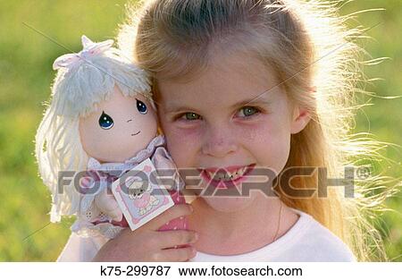 little girl and her new doll View Large Photo Image Stock Photo - little girl and her new doll. Fotosearch