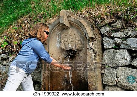 Stock Image - little girl at a fountain in Aigual massif, Gard department, Languedoc-Roussillon region, France, Europe. Fotosearch