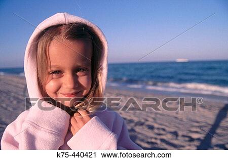 Little girl at beach with hood up View Large Photo Image Stock Image - Little girl at beach with hood up. Fotosearch