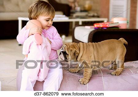 Little girl at home wiyh her puppy View Large Photo Image Stock Photo - Little girl at home wiyh her puppy. Fotosearch