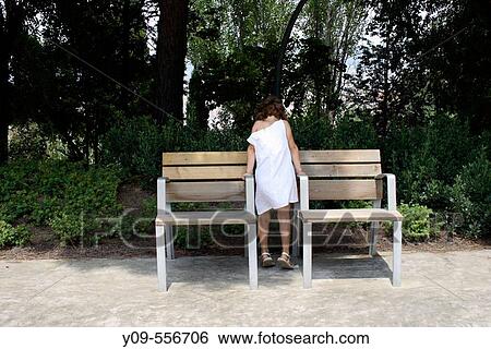 Little girl between two benches. View Large Photo Image Stock Photograph - Little girl between two benches.. Fotosearch