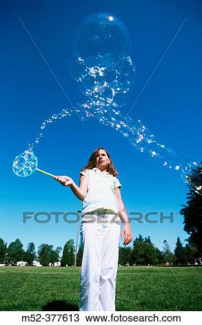 Little girl blowing bubbles View Large Photo Image Stock Image - Little girl blowing bubbles. Fotosearch