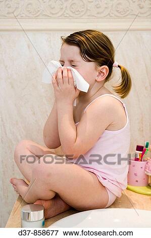 Little girl blowing her nose in the bathroom View Large Photo Image Stock Photo - Little girl blowing her nose in the bathroom. Fotosearch