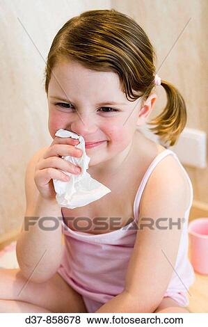 Stock Photo - Little girl blowing her nose. Fotosearch