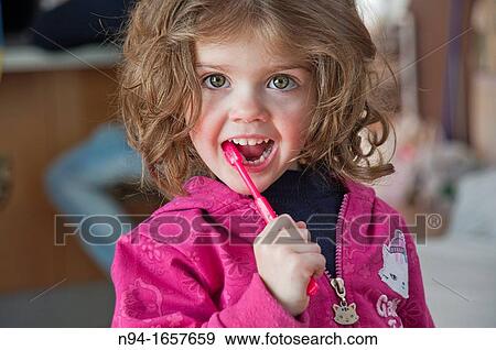 Stock Photo - Little girl brushing her teeth. Fotosearch