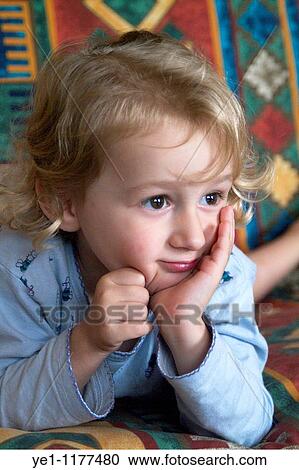 Little girl captivated by a TV programme, France. View Large Photo Image Stock Image - Little girl captivated by a TV programme, France.. Fotosearch