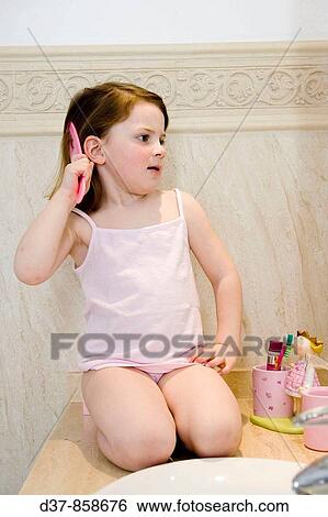 Little girl combing her hair View Large Photo Image Stock Photograph - Little girl combing her hair. Fotosearch