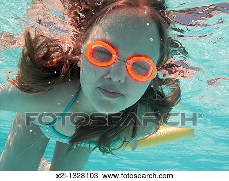 Stock Image - Little girl diving in the pool. Fotosearch
