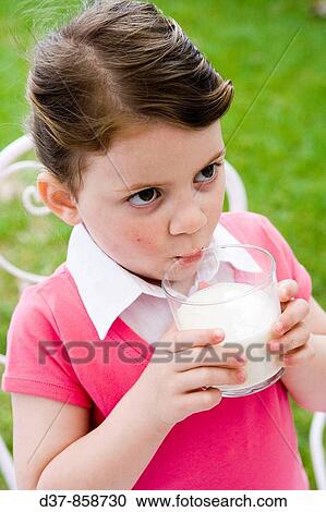 Little girl drinking a glass of milk View Large Photo Image Stock Image - Little girl drinking a glass of milk. Fotosearch