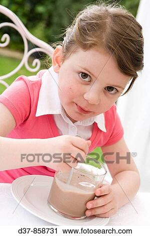 Little girl drinking cacao milk View Large Photo Image Stock Image - Little girl drinking cacao milk. Fotosearch