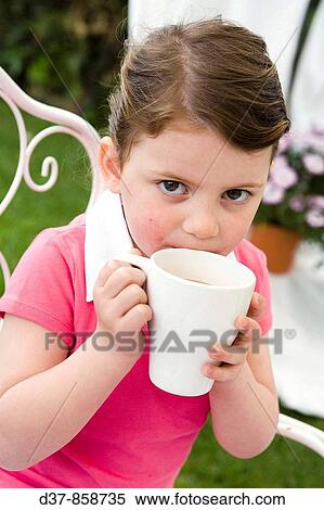 Little girl drinking caccao milk View Large Photo Image Stock Photography - Little girl drinking caccao milk. Fotosearch