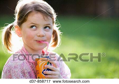 Little girl drinking soda in the garden View Large Photo Image Stock Photo - Little girl drinking soda in the garden. Fotosearch