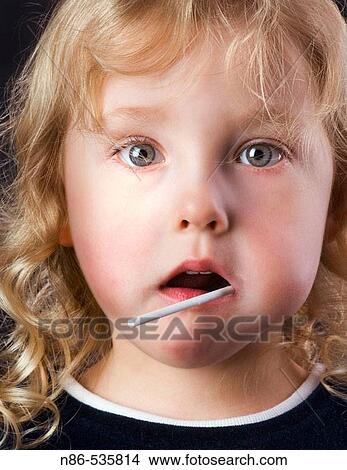Picture - Little girl eating a sucker. Fotosearch