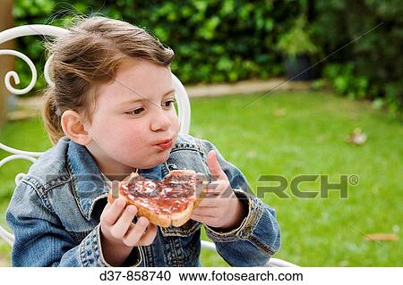 Little girl eating bread with jam View Large Photo Image Stock Image - Little girl eating bread with jam. Fotosearch