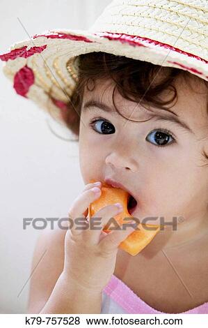 Little girl eating fruit. View Large Photo Image Stock Photo - Little girl eating fruit.. Fotosearch