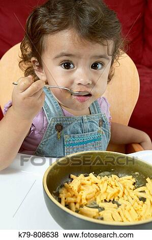 Little girl eating macaroni and cheese. View Large Photo Image Stock Photo - Little girl eating macaroni and cheese.. Fotosearch