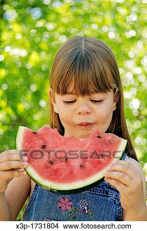 Little girl eating watermelon View Large Photo Image Picture - Little girl eating watermelon. Fotosearch