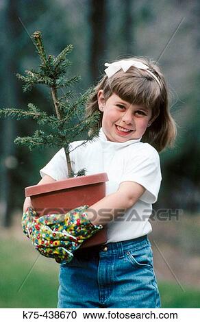 Little girl helping with tree planting View Large Photo Image Stock Image - Little girl helping with tree planting. Fotosearch