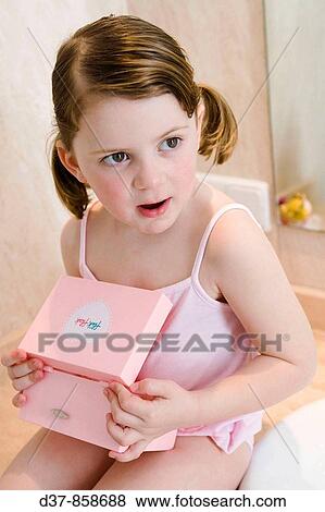 Little girl holding a beauty box View Large Photo Image Stock Photo - Little girl holding a beauty box. Fotosearch