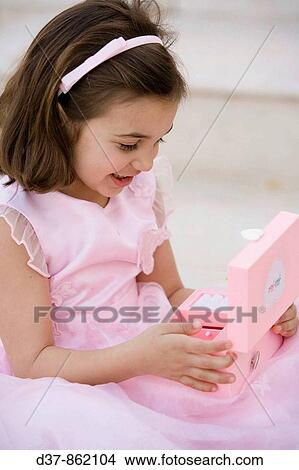 Little girl holding a music box View Large Photo Image Picture - Little girl holding a music box. Fotosearch