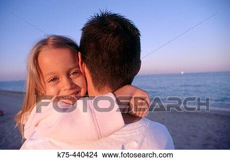 Little girl hugging daddy at beach View Large Photo Image Picture - Little girl hugging daddy at beach. Fotosearch